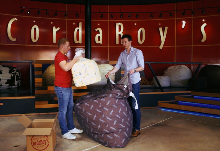 Two guys show how to fill a CordaRoy's Bean Bag Chair. 