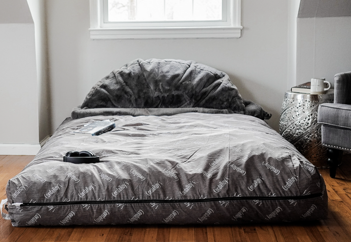 A CordaRoy's bean bag bed convertible on the floor. 