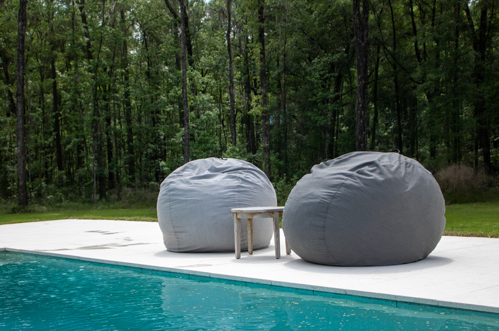 Two CordaRoy's Outdoor Bean Bags by the pool.