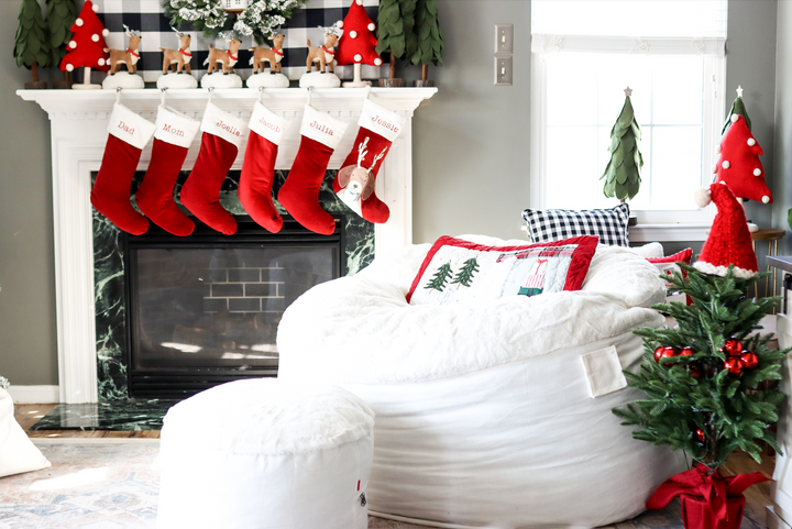 A cordaroys bean bag chair in a living room decorated for the holidays. 