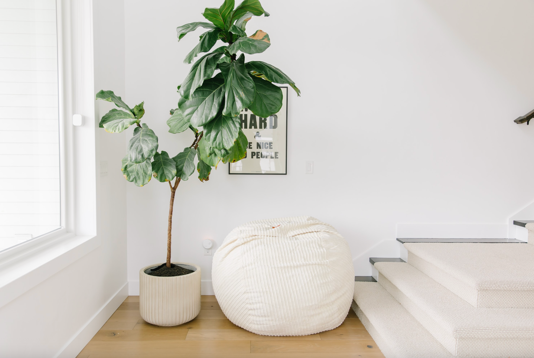 A cordaroys bean bag next to a corner in a room with stairs. 