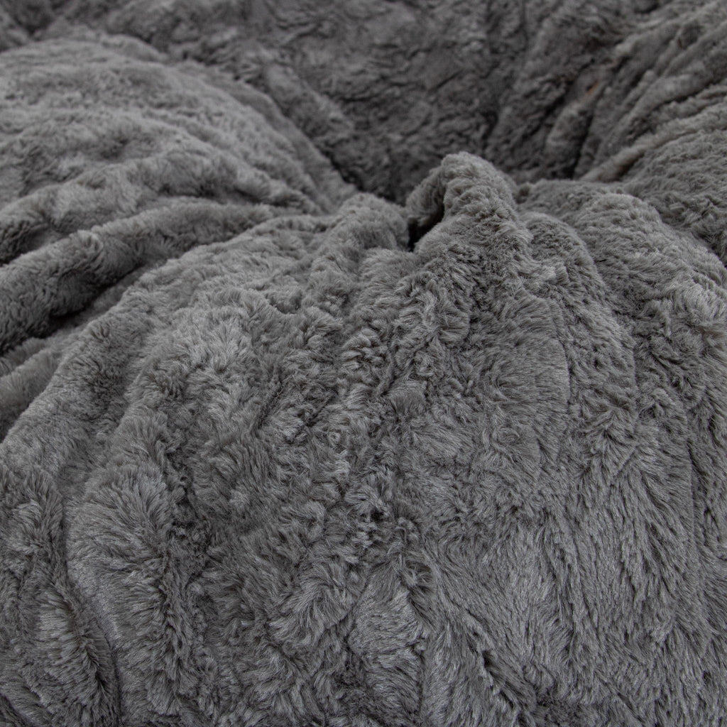 A close-up of cordaroys faux fur gray cover for their pillow lounger.