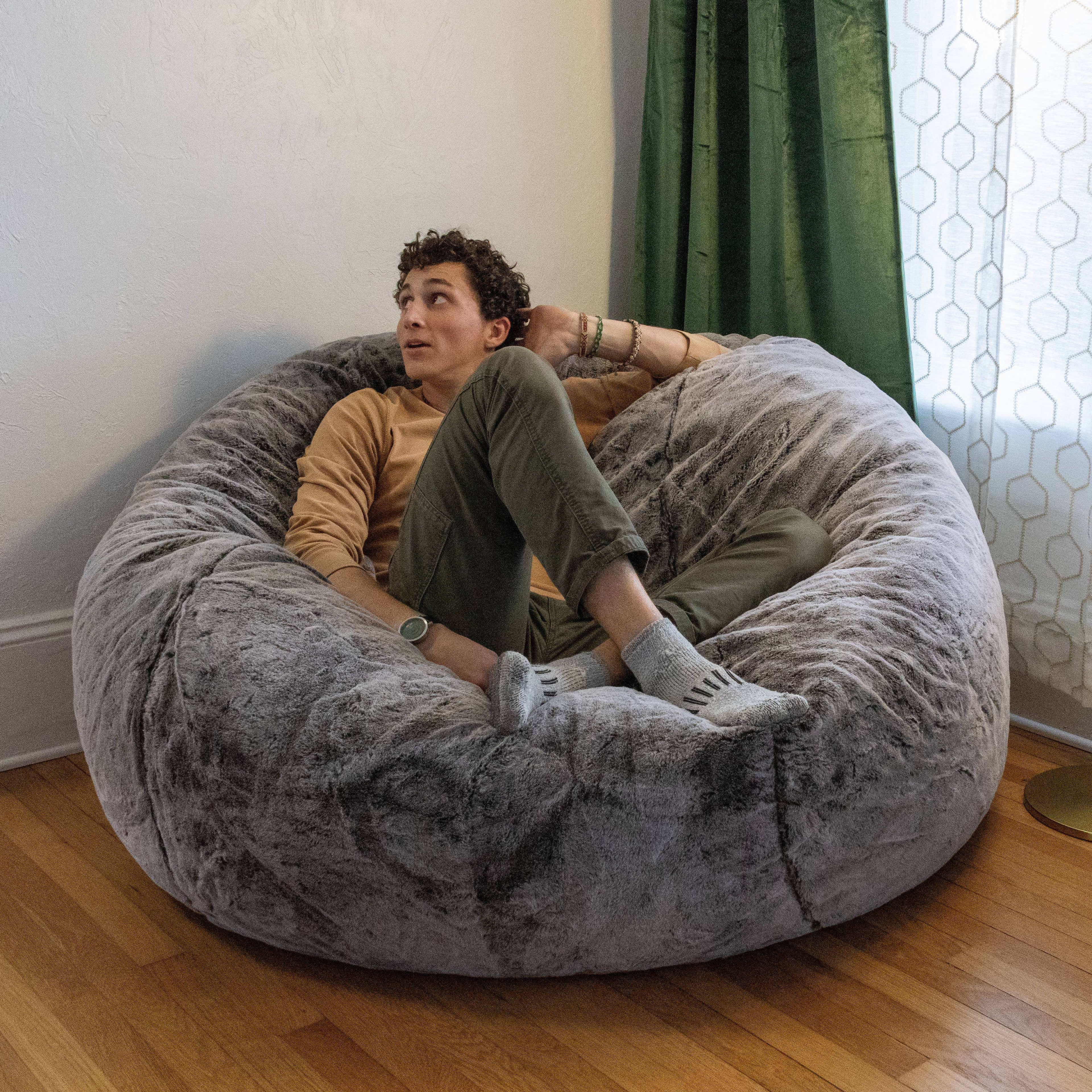 A teenager sits on a king-sized cordaroys bean bag in Chinchilla. 
